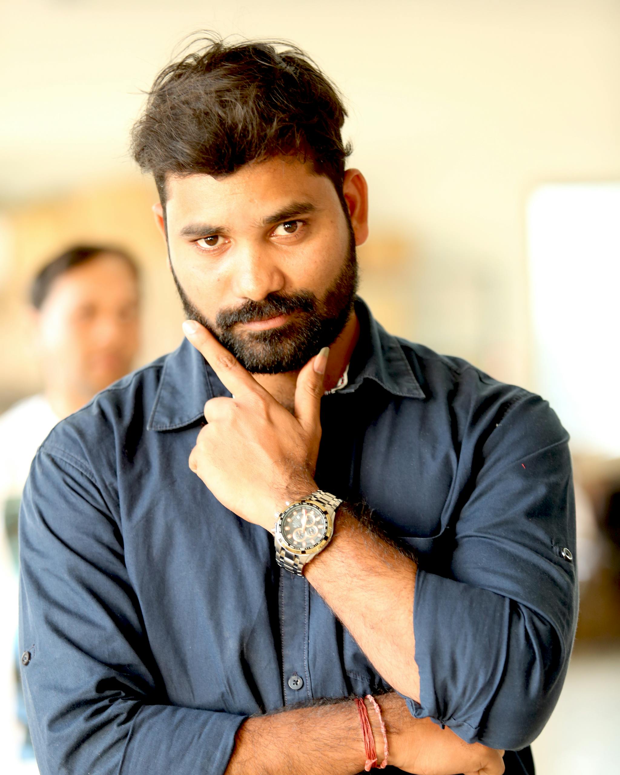 a-stylish-man-with-a-beard-poses-confidently-indoors-showcasing-a-casual-yet-trendy-fashion-statement